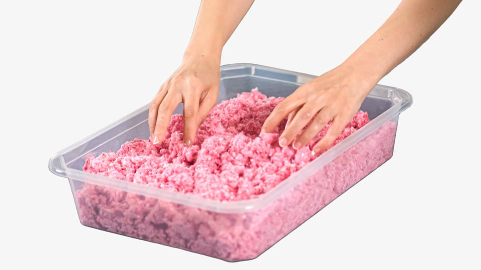 Woman hands mix Belka pink wall covering that is in a storage box.