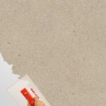 Belka Y2502 Portland Stone wallpaper in a modern living room, warm greige (creamy taupe) wall finish