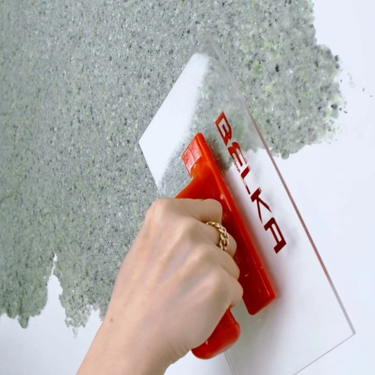Applying Belka cotton plaster with a plastic trowel
